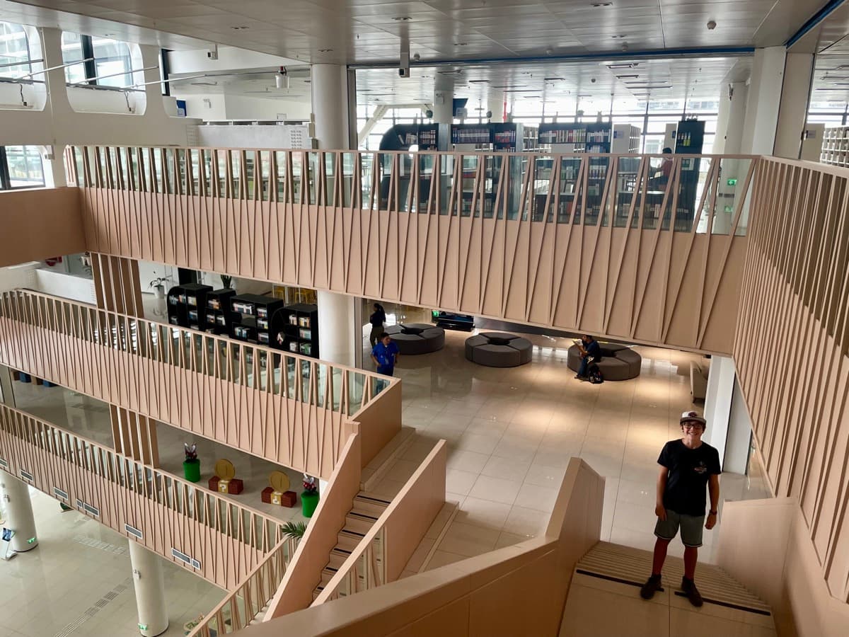 My son standing in the stunning multi-level San Salvador national library
