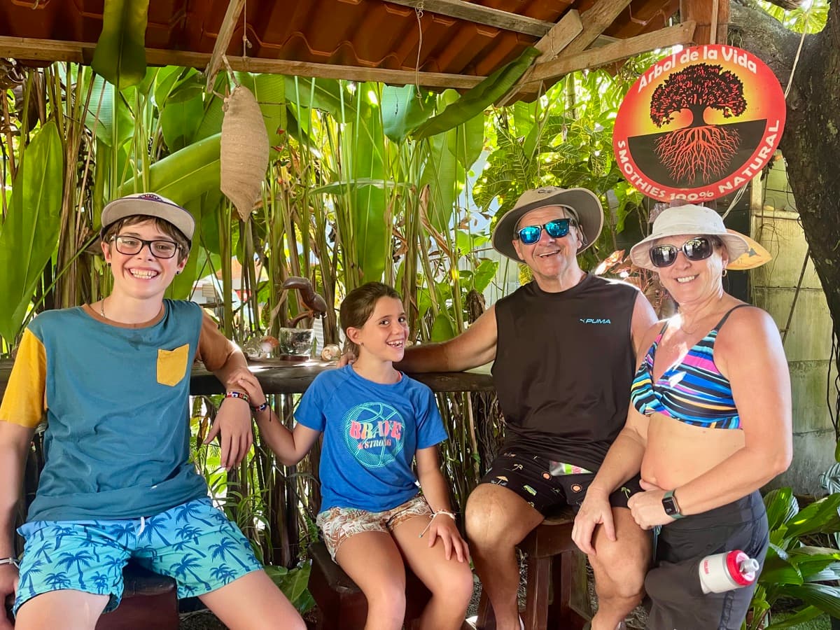 The whole family relaxing at a local spot in Costa Rica surrounded by tropical plants