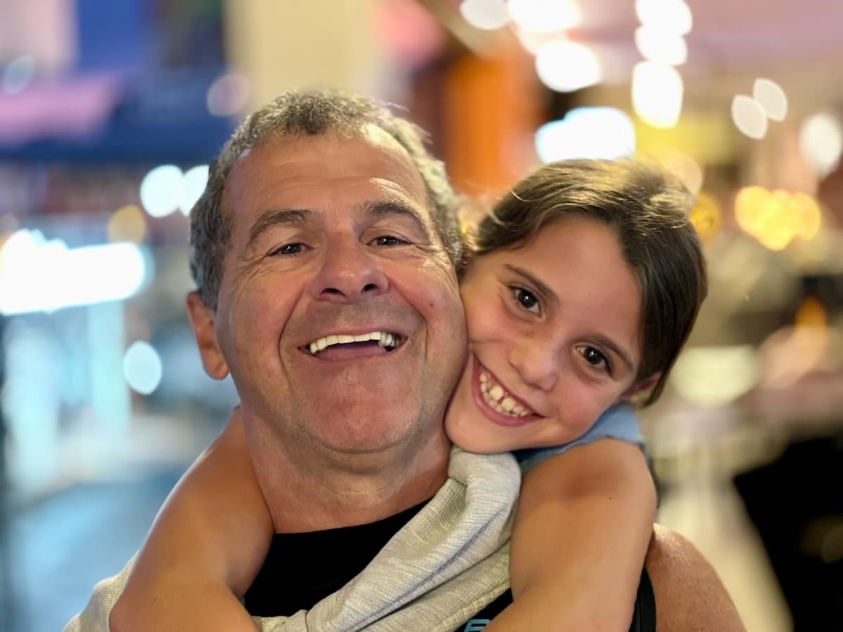 Papi and his granddaughter smiling together, pure joy