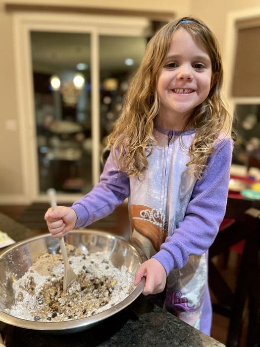 A girl mixing batter in a big bowl