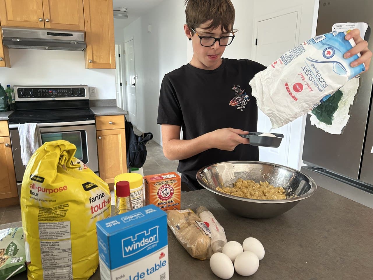 A homeschooled middle schooler measuring ingredients and baking from scratch in the kitchen, working independently