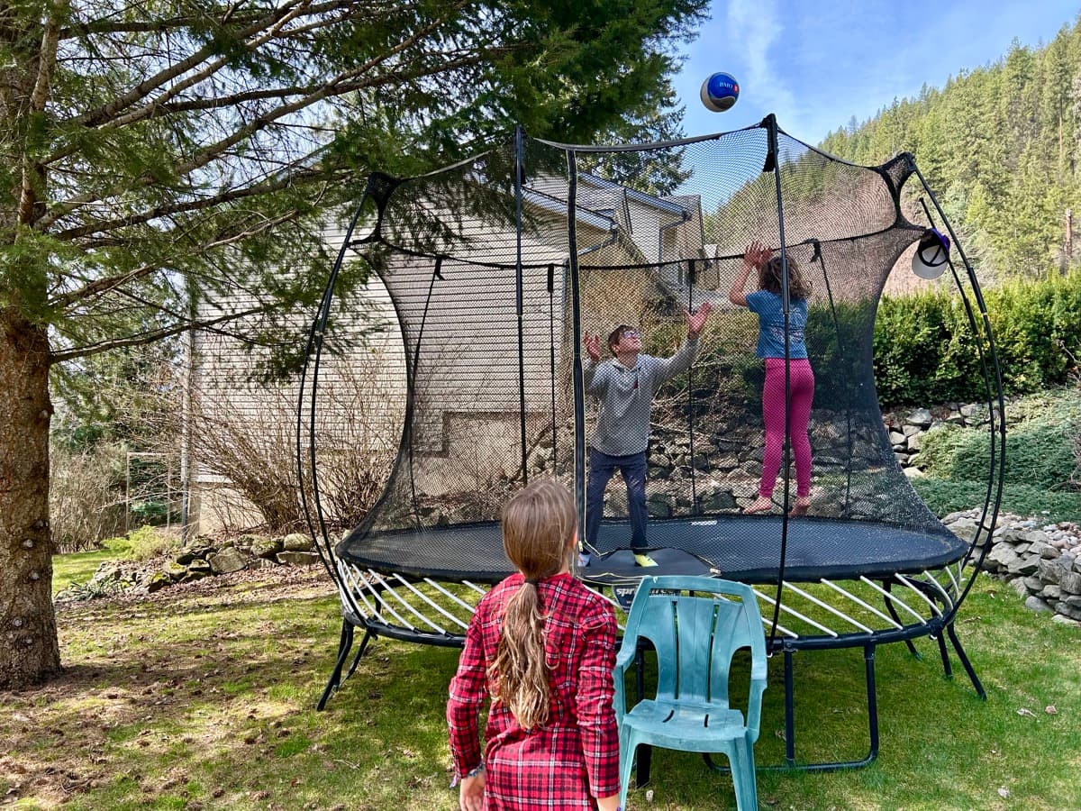 Julia, Zach, and a friend playing Get Blocked on the trampoline