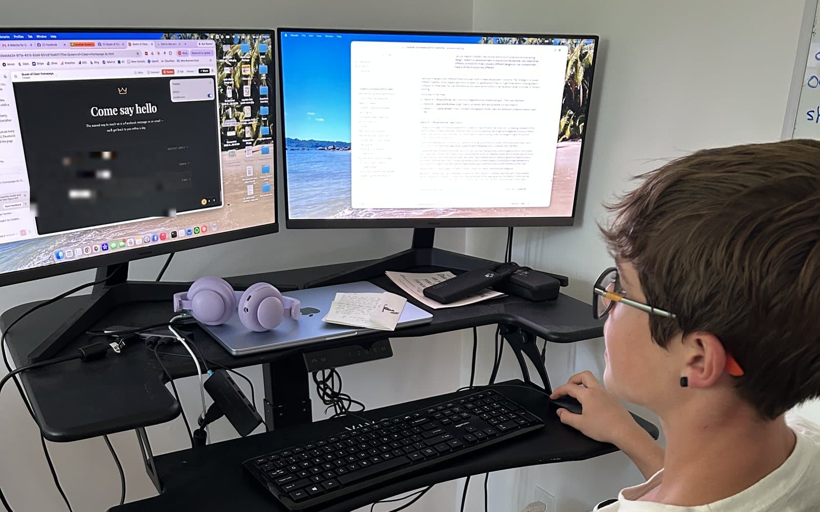 A teen at a two-monitor desk working on a website he is building, using the computer to create real work rather than just consume it