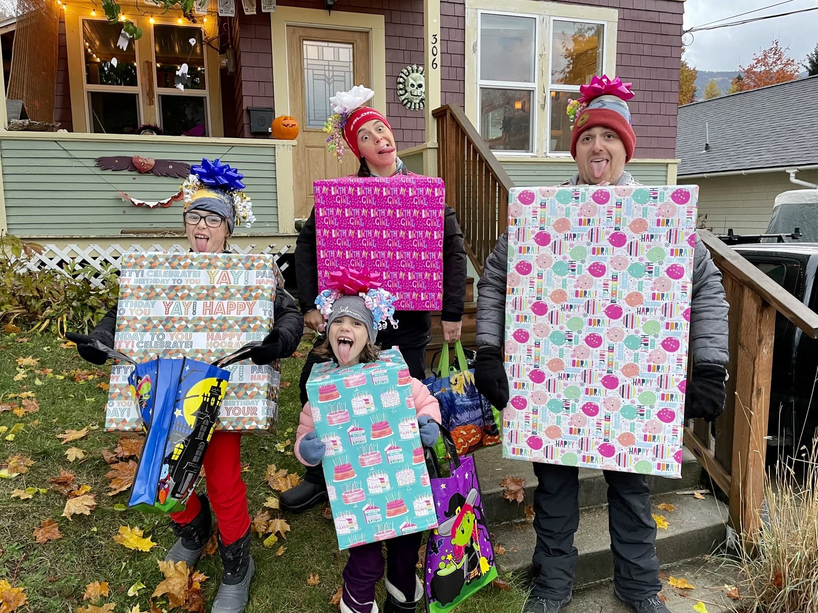The whole family dressed as wrapped Christmas presents, costumes made entirely from wrapping paper and cardboard