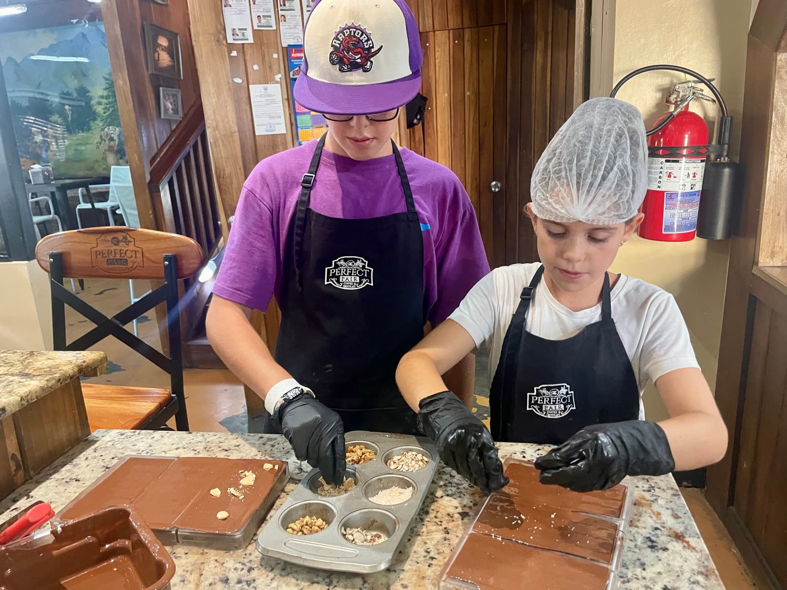 My son and another kid making chocolate at a workshop, hands-on, project-based learning