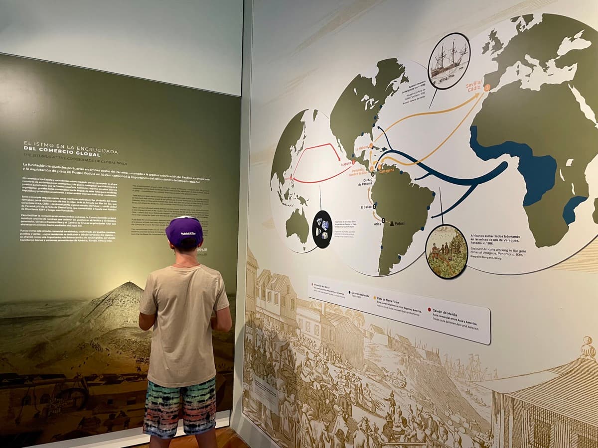My son studying a global trade route map at the Panama Canal museum