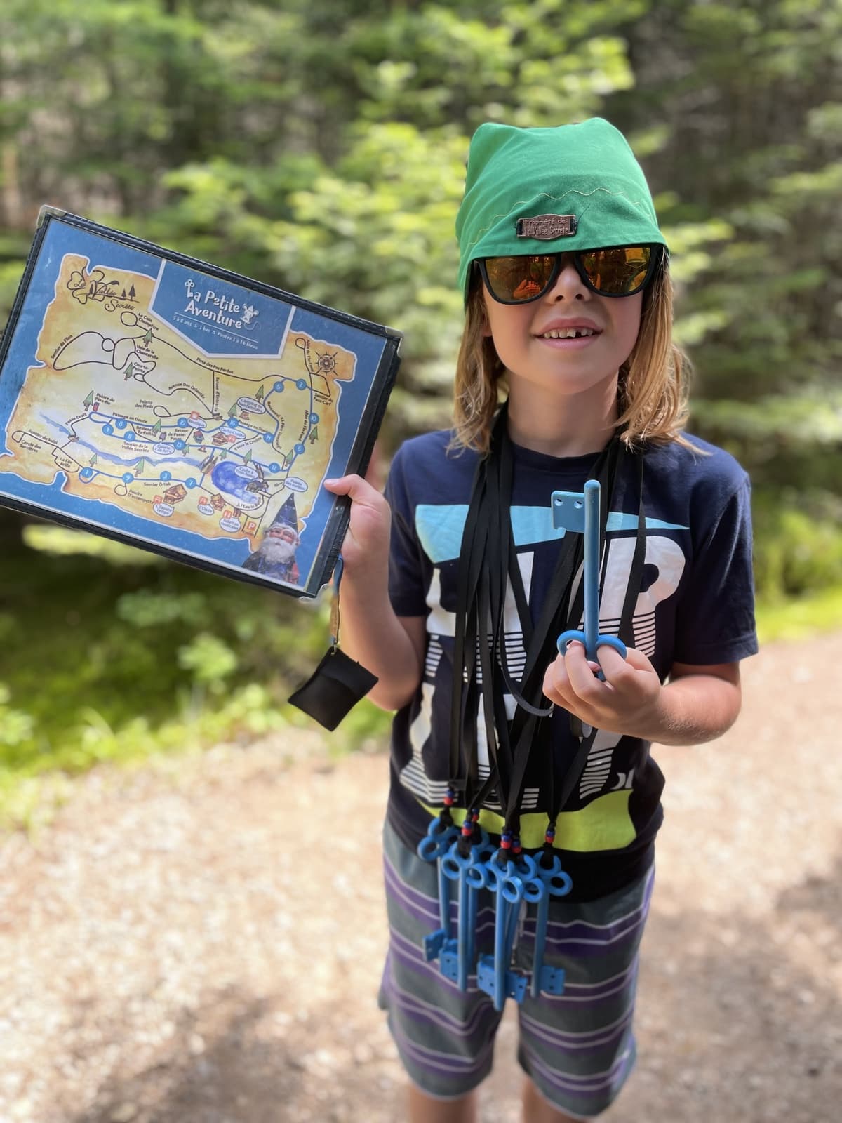 Zach holding a hand-drawn treasure map outdoors, ready for an adventure