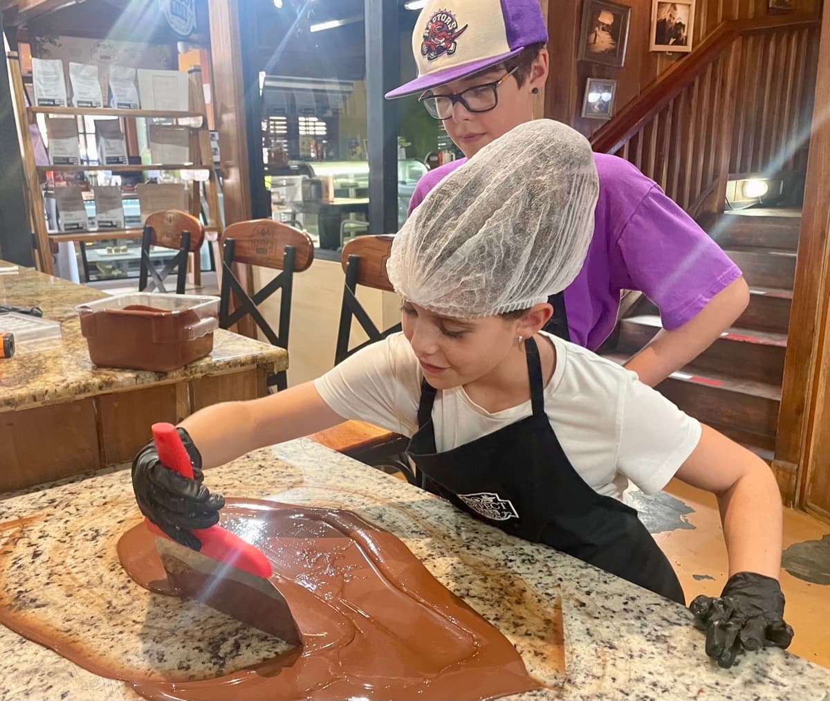 Zach and Julia tempering chocolate at a workshop in Bocas del Toro, Panama